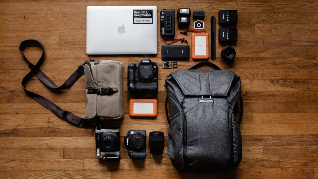 A camera bag with various camera items at its side
